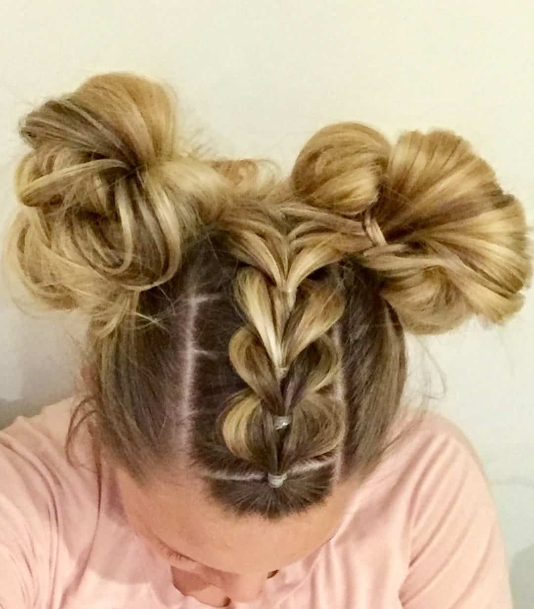 two buns with a pull through braid into them