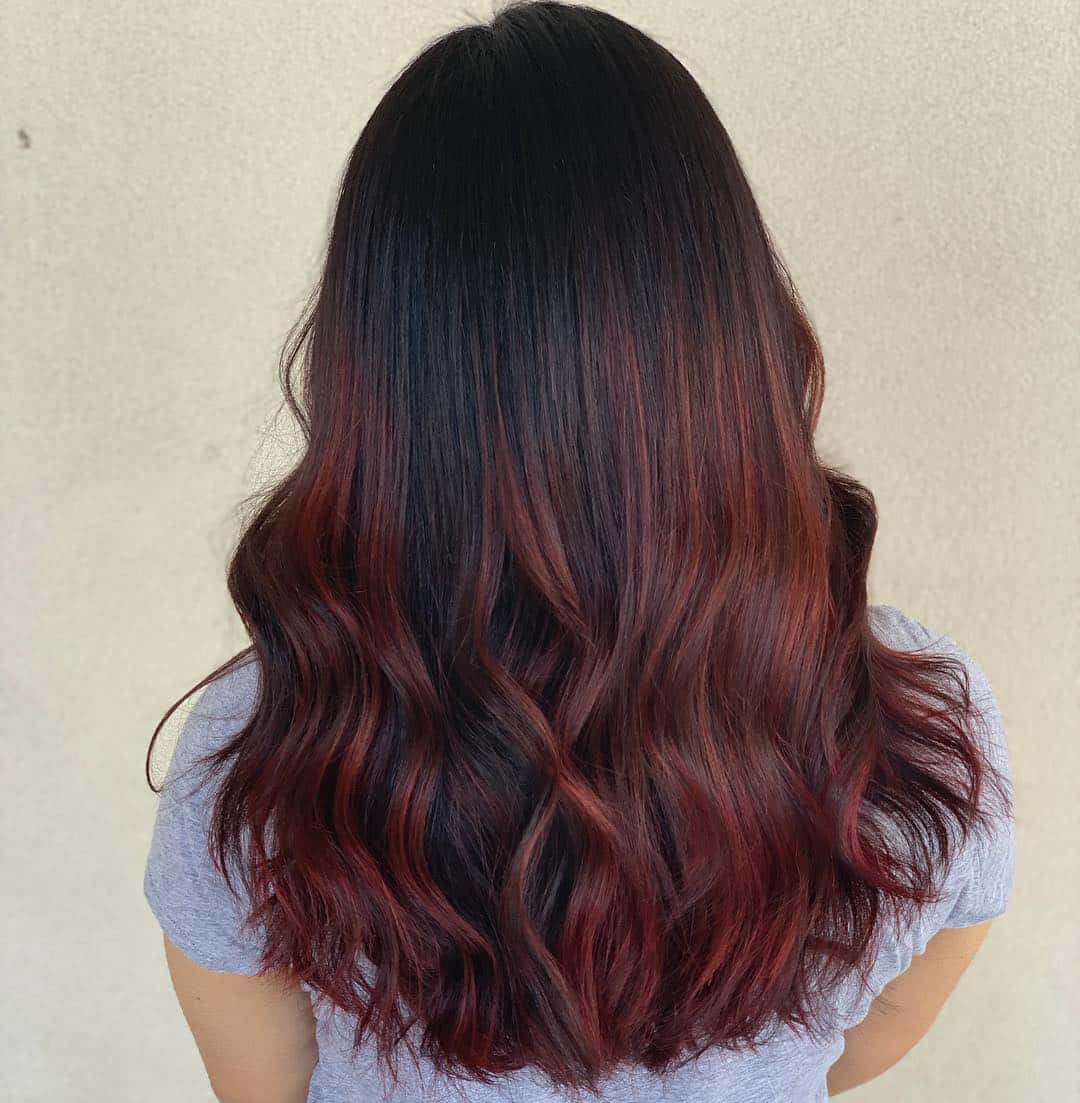 Dark Red Balayage On Long Soft Waves