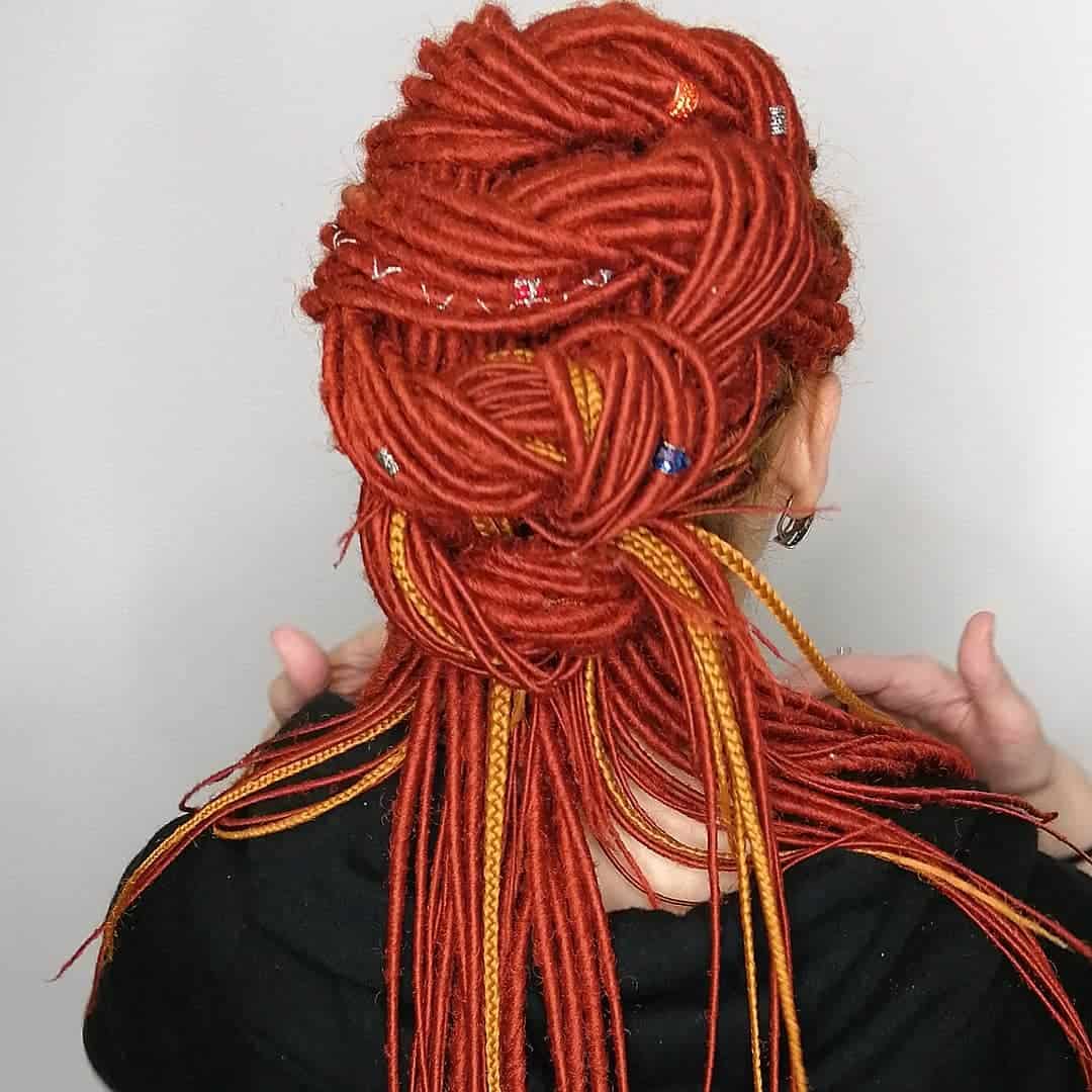 Burnt Orange Dreadlocks And Yellow Braids Tied In Knots