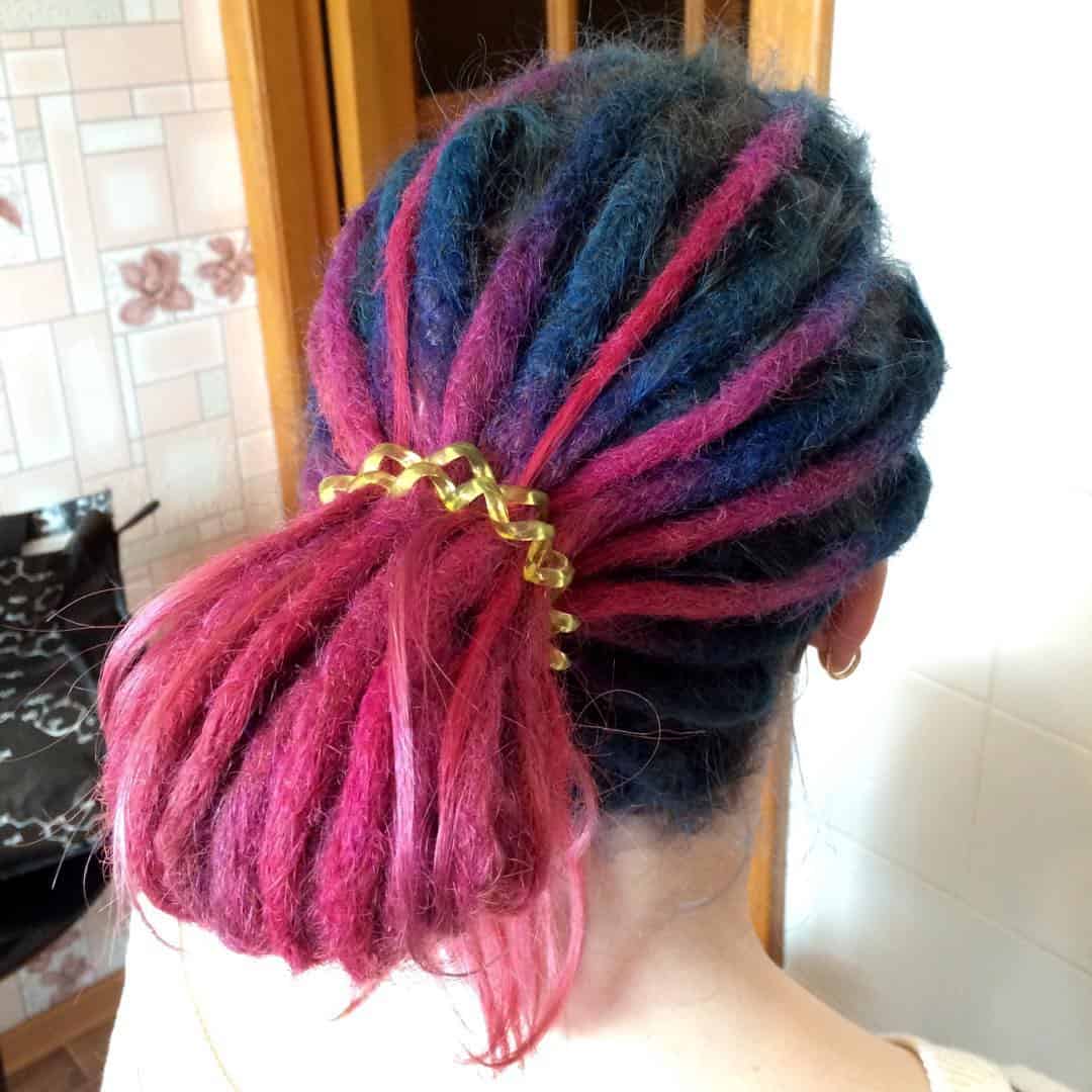 Elegant Pink And Blue Ombre Dreadlocks In Low Bun