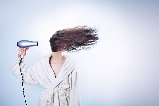 woman with hair dryer