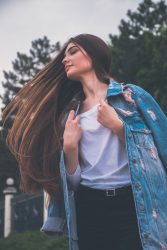 woman holding her white shirt flipping hair