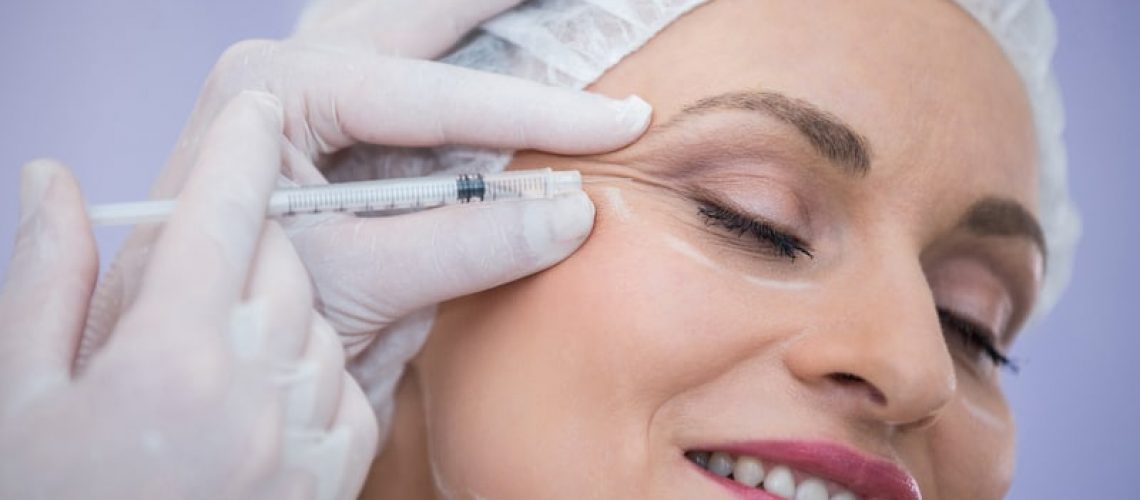 Close-up of woman receiving botox injection at clinic