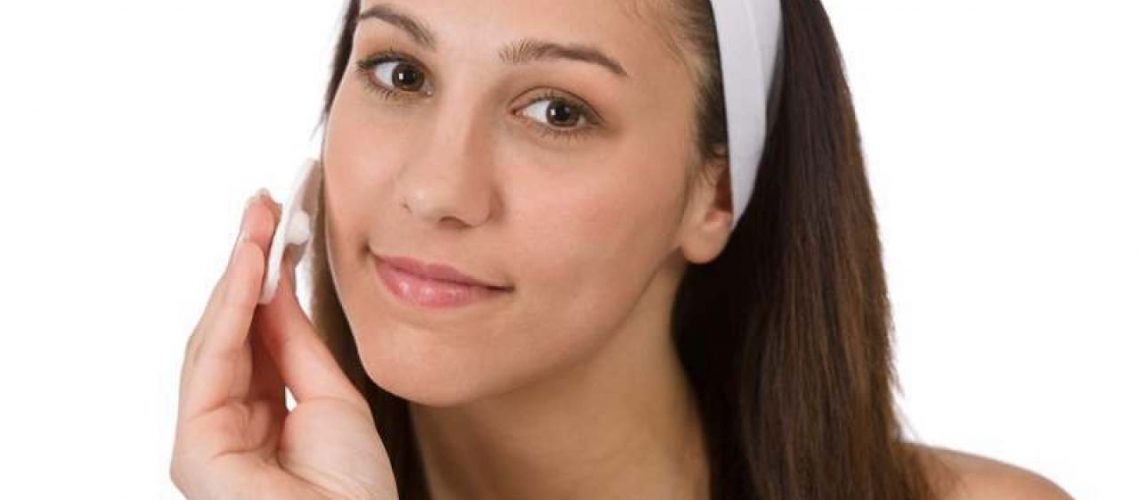 girl putting face mask